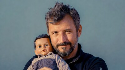 Man holding realistic baby doll