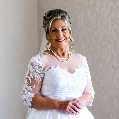 Smiling mature bride in lace wedding dress