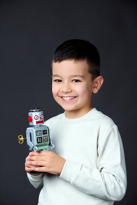 Asian boy holding toy robot