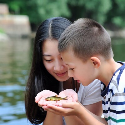 Asian girl and boy holding small fish