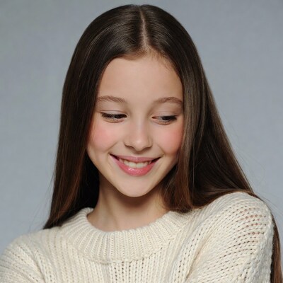 Smiling girl in white sweater