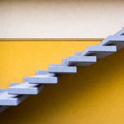 Gray Concrete Stairs Against Yellow Wall