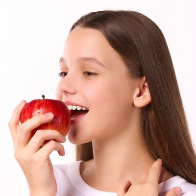 Girl biting red apple