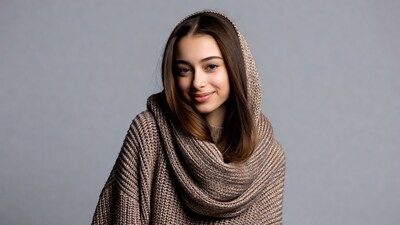 Smiling woman in hooded knit sweater