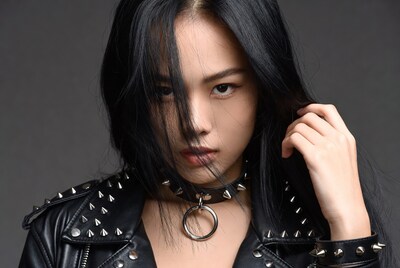 Asian woman in spiked leather jacket
