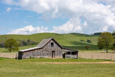 Old wooden barn in green hills
