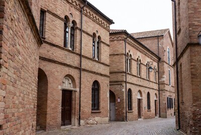 Narrow cobblestone alley with brick buildings
