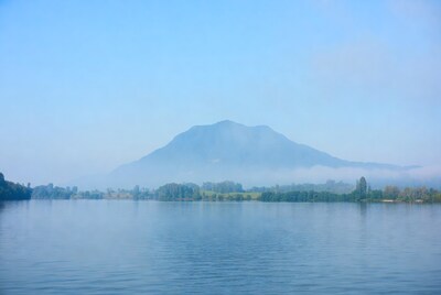 Mountain reflected in misty lake