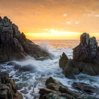 Ocean Waves Crashing on Rocks at Sunset