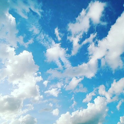 Fluffy white clouds in blue sky