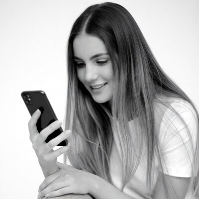 Woman smiling at smartphone