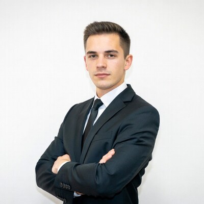 Young man in suit with arms crossed