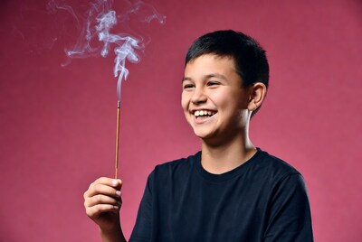 Asian boy holding incense stick