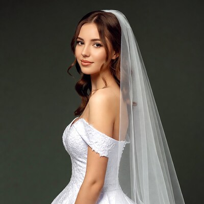 Bride in white lace gown with veil