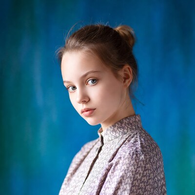 Young woman with bun on blue background