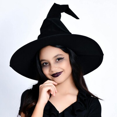 Girl in witch hat smiling