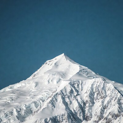 Snowy Mountain Peak Against Blue Sky