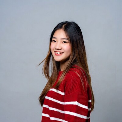 Asian girl smiling in red striped sweater