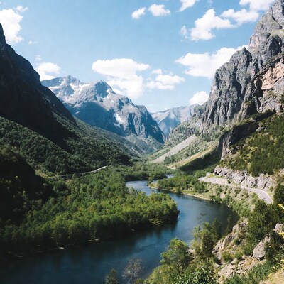 Mountain Valley with River and Winding Road