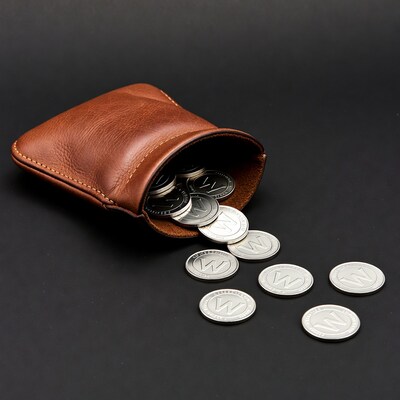 Brown leather pouch spilling silver W coins