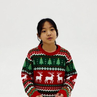 Asian girl in Christmas reindeer sweater