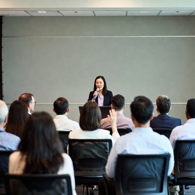Asian woman speaking at conference podium