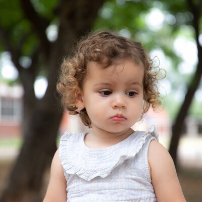 Curly-haired toddler girl outdoors
