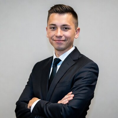 Young man in suit with arms crossed