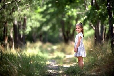 Girl smiling in forest path