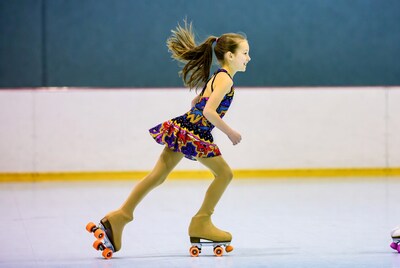 Girl roller skating on rink