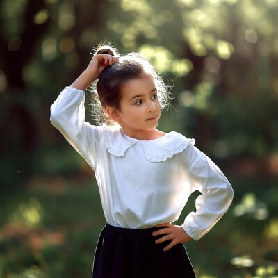 Girl fixing hair in forest