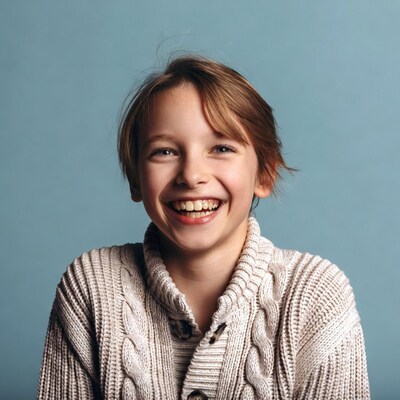 Boy smiling in white sweater
