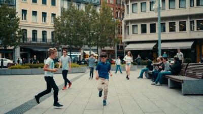 Boys running in urban plaza