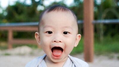 Asian baby boy yelling outdoors