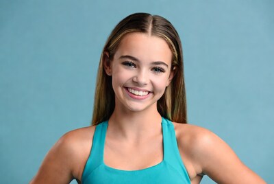 Teen girl smiling in turquoise tank top