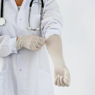 Female doctor putting on gloves