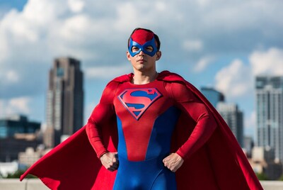 Man in Superman costume with cape