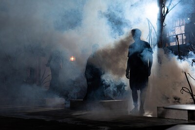 Silhouetted men in foggy night scene