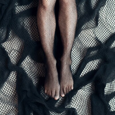 Woman's Legs in Fishnet Stockings