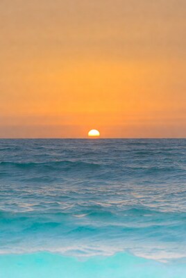 Sunset over ocean waves