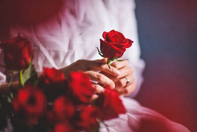 Woman holding red rose