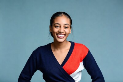 Smiling Black woman in navy red sweater