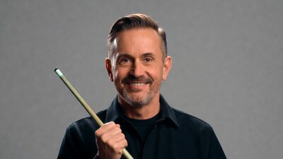 Smiling man holding pool cue