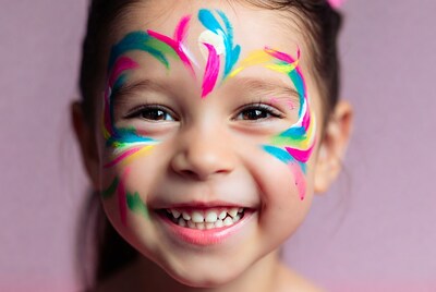 Girl with colorful face paint smiling
