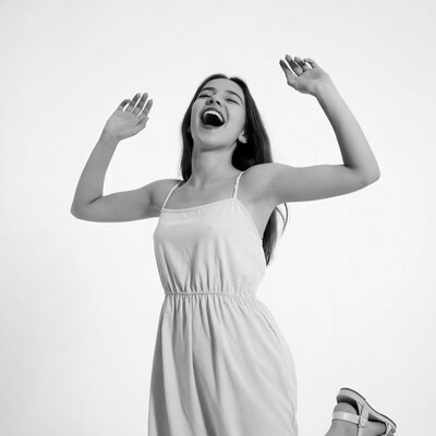 Woman laughing with arms raised