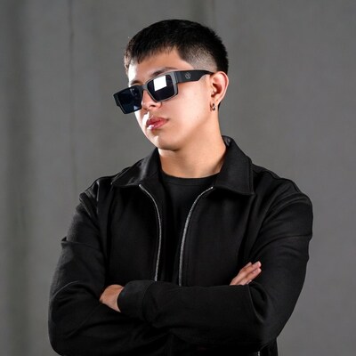 Asian man in sunglasses with arms crossed