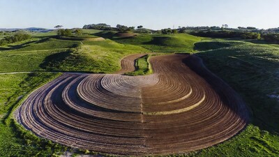 Circular plowed fields in green hills