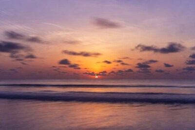 Sunrise over ocean waves
