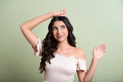 Woman hand on head green background