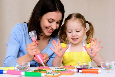 Mother and daughter decorating cookies